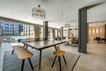 A modern dining room with a large table and chairs.